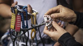 Climbers inspecting cams