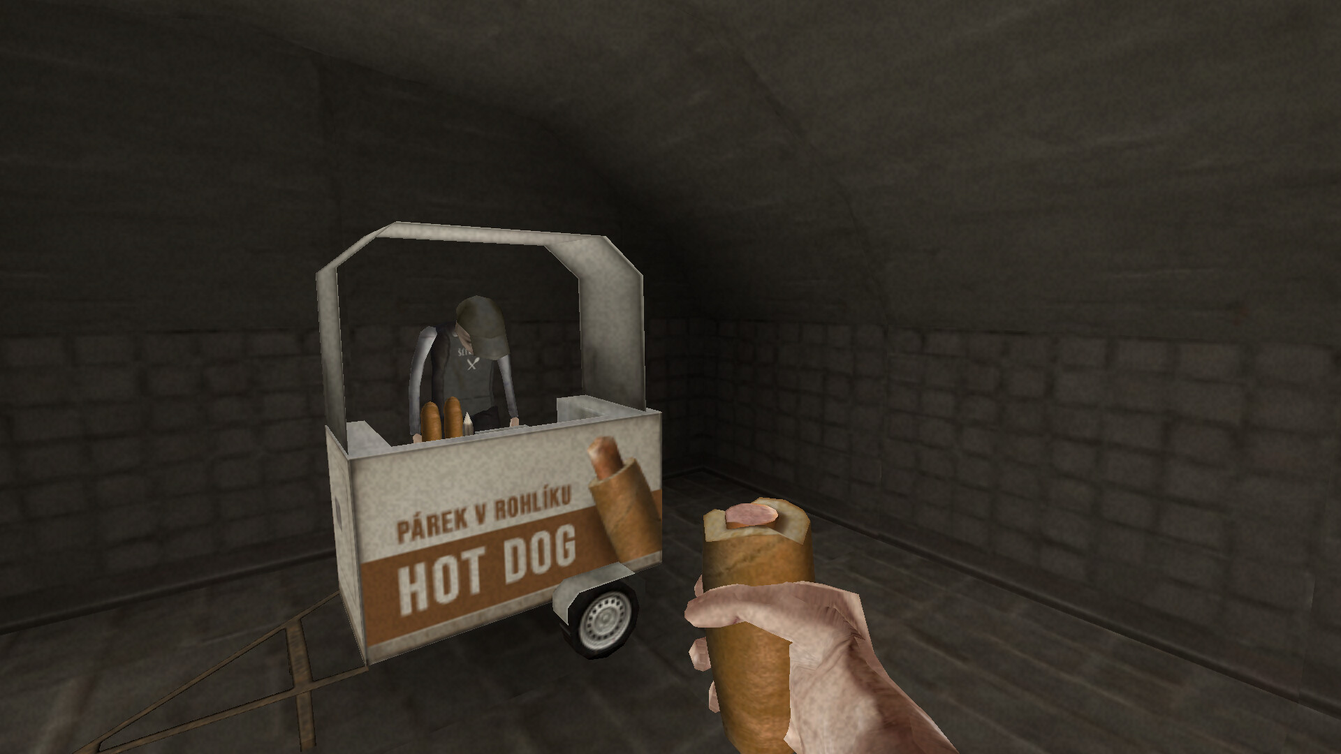 first person view of half-eaten sausage roll/hot dog type thing in front of stand selling them, downcast man running the stand in Brno Transit.