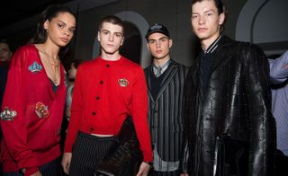 Male models wearing black and red clothes from the Versace S/s 2018 collection