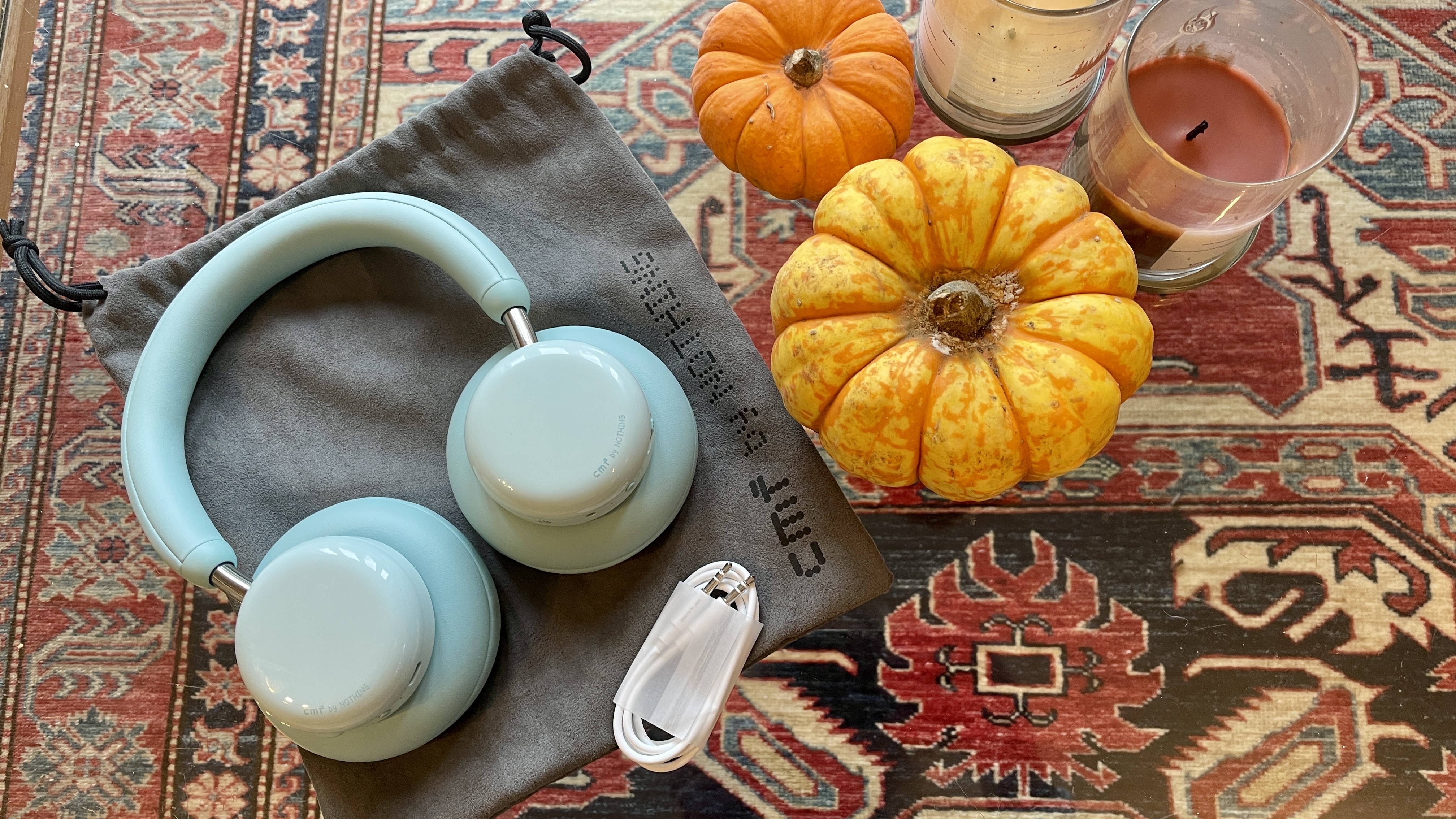 CMF Headphone Pro either beside Nothing Headphone (1) or on a table, with the accessories in the box