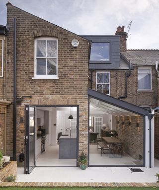 A side kitchen extension on a victorian terraced house with fully open bifold doors