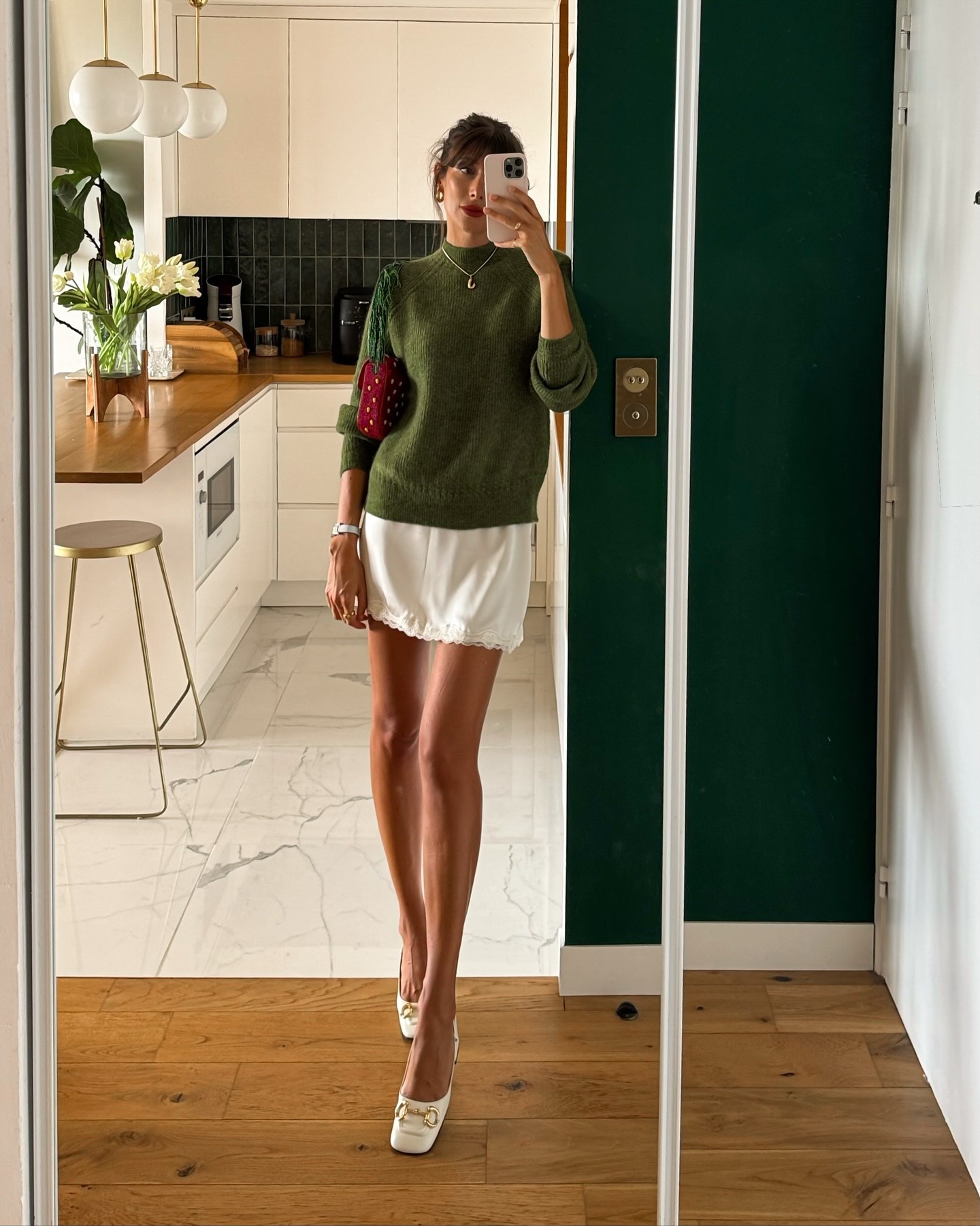 French woman wearing a sweater and lace-trim skirt
