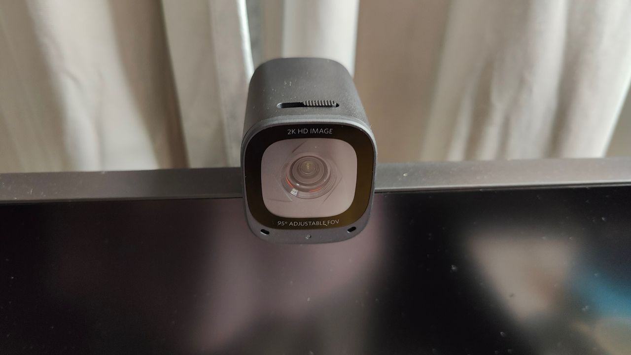 Angled top-down photo of Anker PowerConf C200 webcam mounted on a monitor