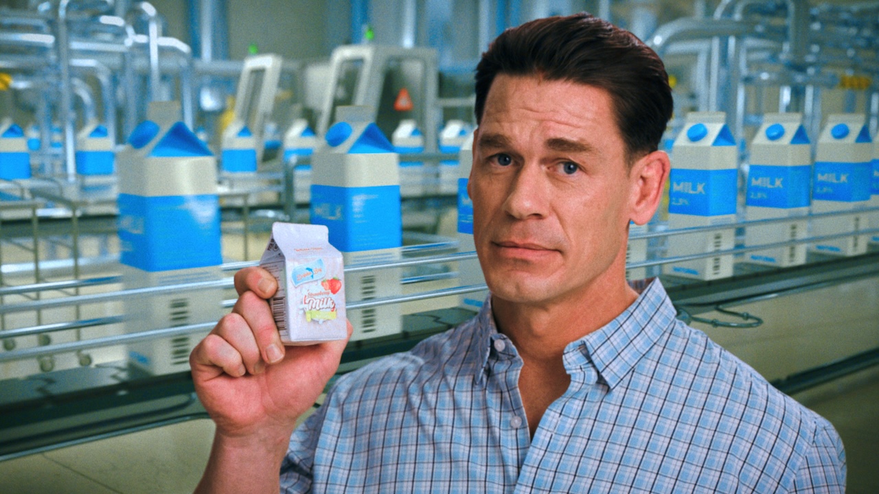John Cena holding small milk carton in Pluribus Episode 6