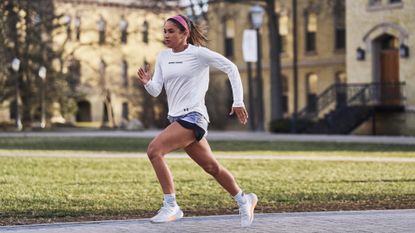 Best women's running shoes: Pictured here, a female runner sprinting on a track wearing the Under Armour HOVR PHANTOM 3