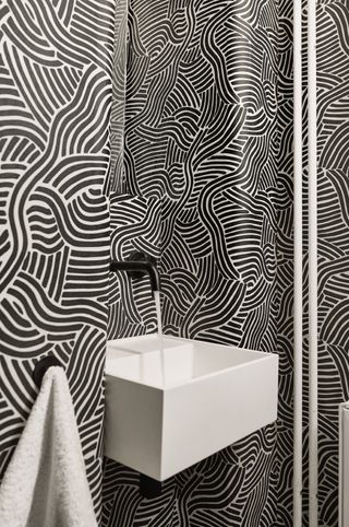 Bold wallpaper around a bathroom sink