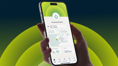 Hand holding mobile with ExpressVPN open at homepage. There is a dark background with green semi-circles