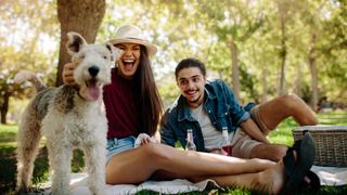 Couple in park with dog