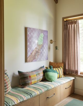 A child's bedroom with cozy window seat