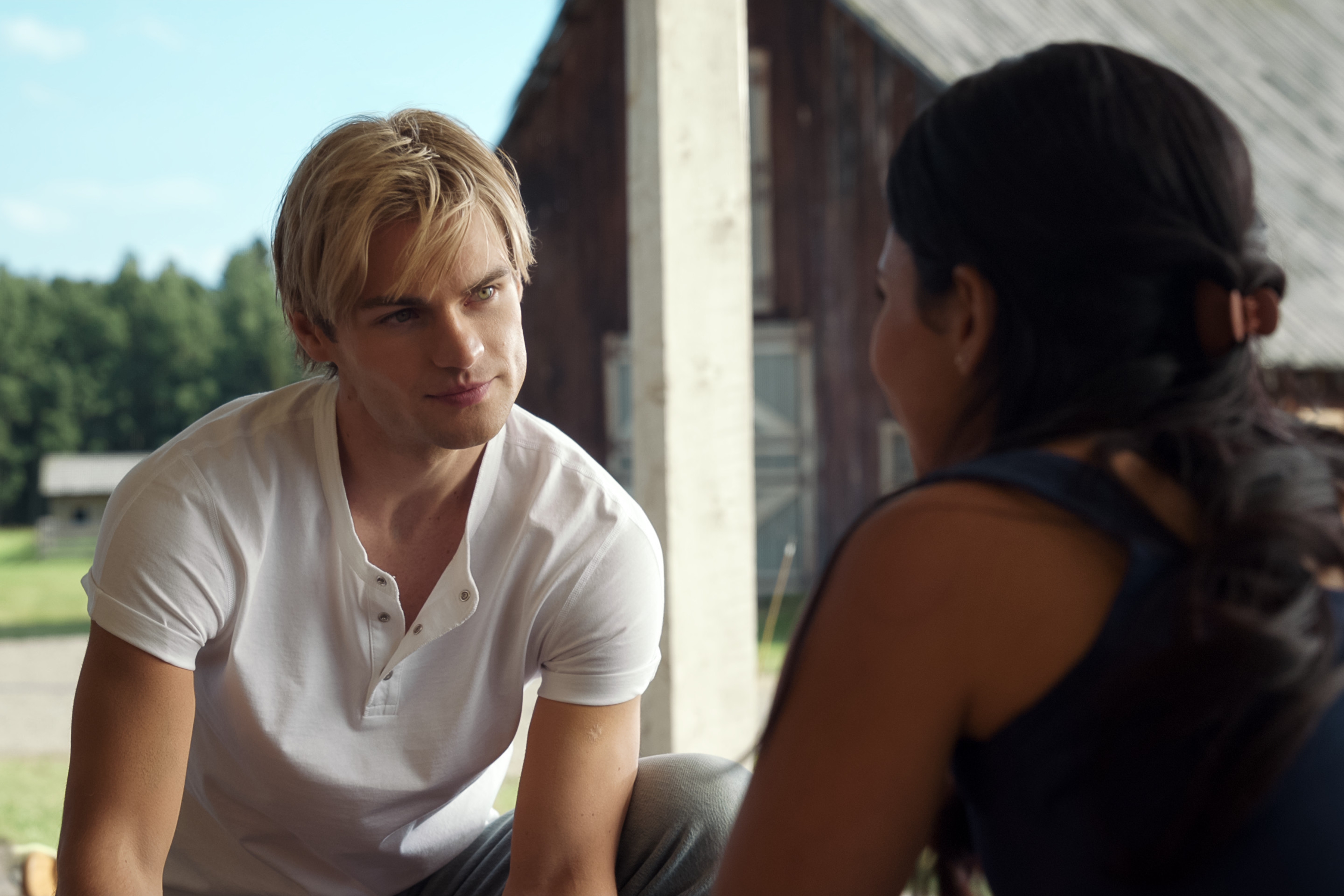 Noah LaLonde as Cole and Nikki Rodriguez as Jackie speaking outside the barn in My Life with the Walter Boys season 2