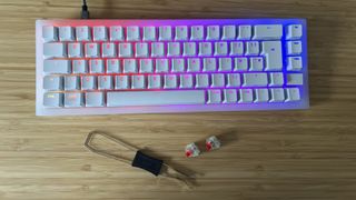 Cherry XTRFY K5V2 gaming keyboard on a wooden desk with switches and swapping tool below