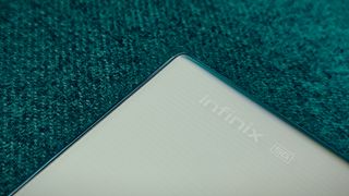 An Infinix Note 40 Pro Plus smartphone on a green sofa