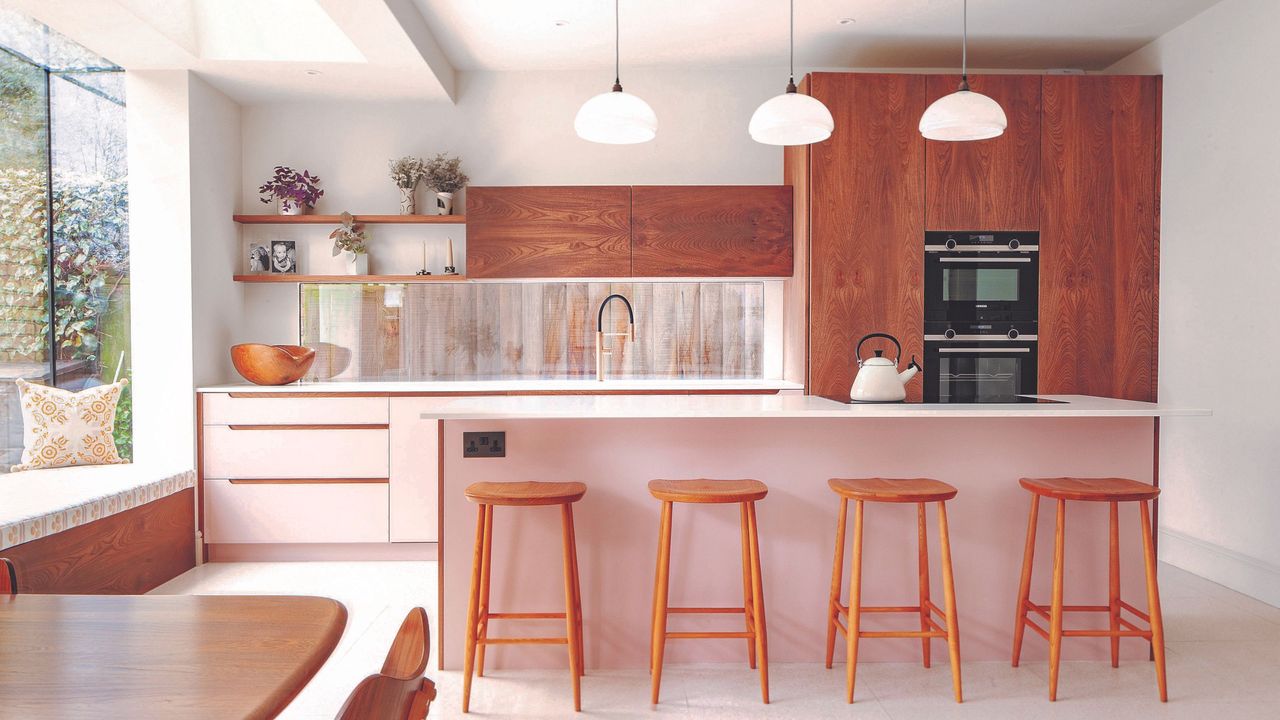 Pink kitchen rennovation with terrazzo wooden stools and bar island