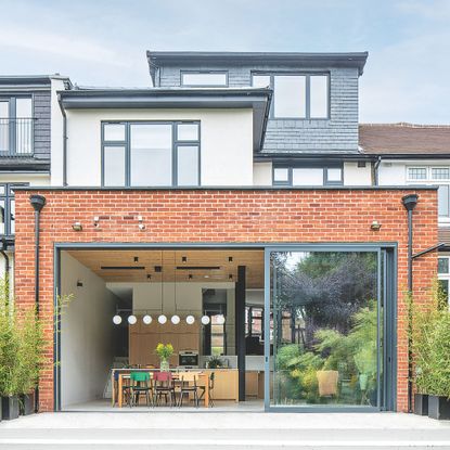 Brick extension with large aluminium sliding doors to the patio