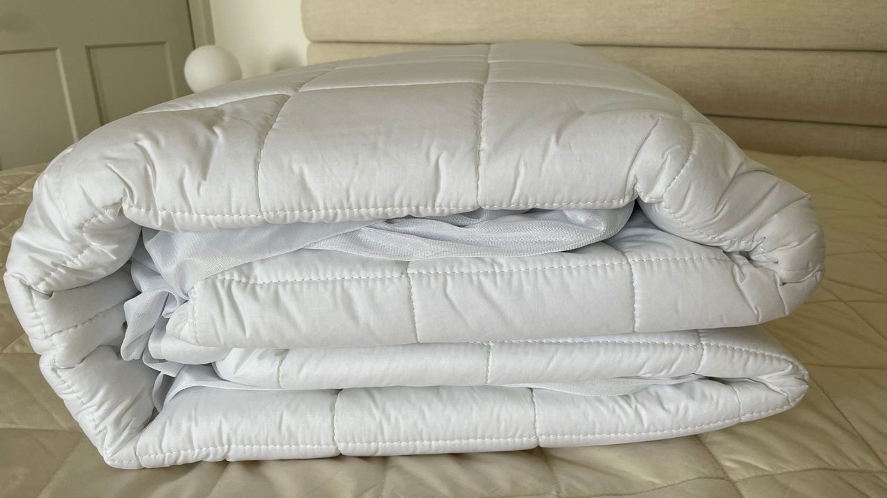 Dreamland Snowed In Organic Cotton Electric Blanket rolled up on the bed