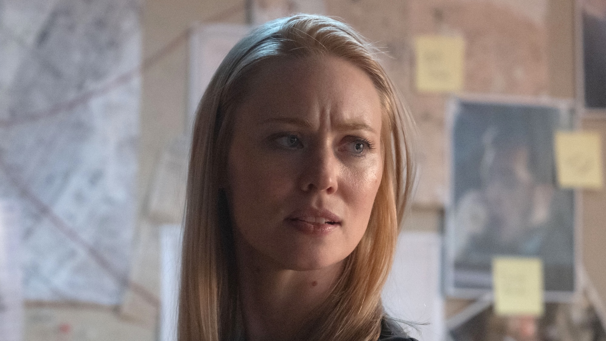 Karen looking concerned while standing in front of an evidence board with strings tying maps to photographs and notes in Daredevil: Born Again Season 2