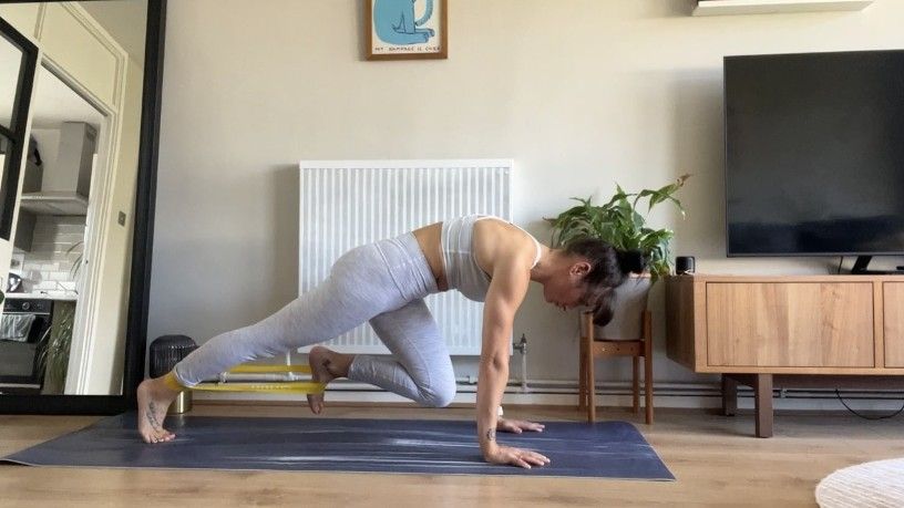 Writer Sam performing banded mountain climbers at home on exercise mat