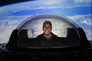 Inspiration4 astronaut Sian Proctor tries out SpaceX's new cupola window for its Crew Dragon spacecraft before it was installed on the vehicle.