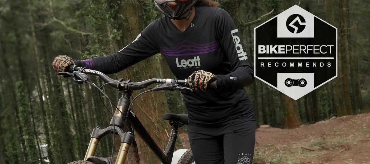 RIder pushing bike wearing Leatt Women’s MTB Gravity 4.0 Jersey 