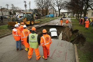 Another view of the sinkhole that emerged in April 2013 in South Deering in Chicago. Three vehicles were caught in the hole; the driver of one vehicle, a truck, had to be hospitalized.