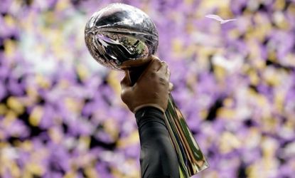 Ray Lewis #52 of the Baltimore Ravens holds up the Vince Lombardi Trophy after defeating the San Francisco 49ers.