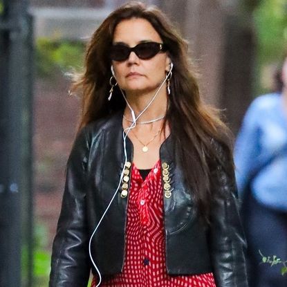 Katie Holmes was spotted in New York wearing tomato red ballet flats, a matching shirt dress, and black leggings
