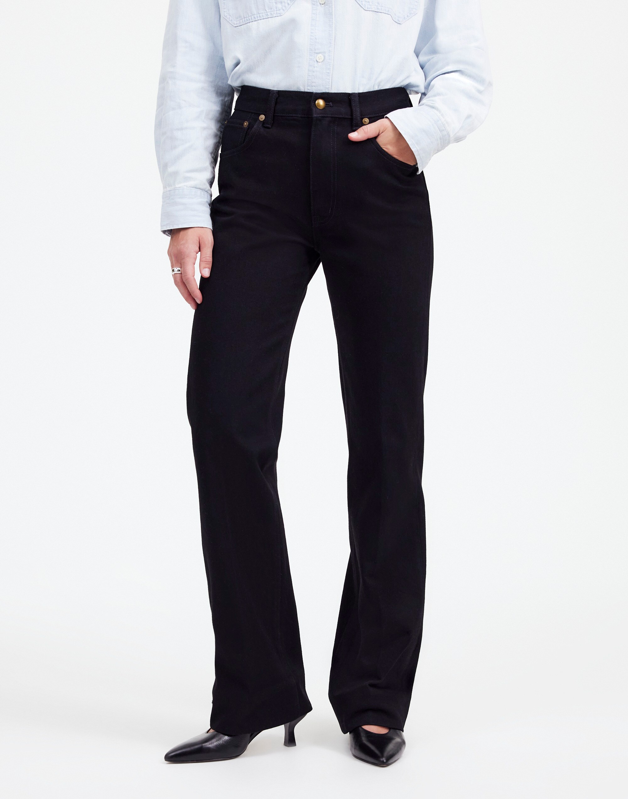 a model wears alexa chung for madewell jeans in front of a plain backdrop