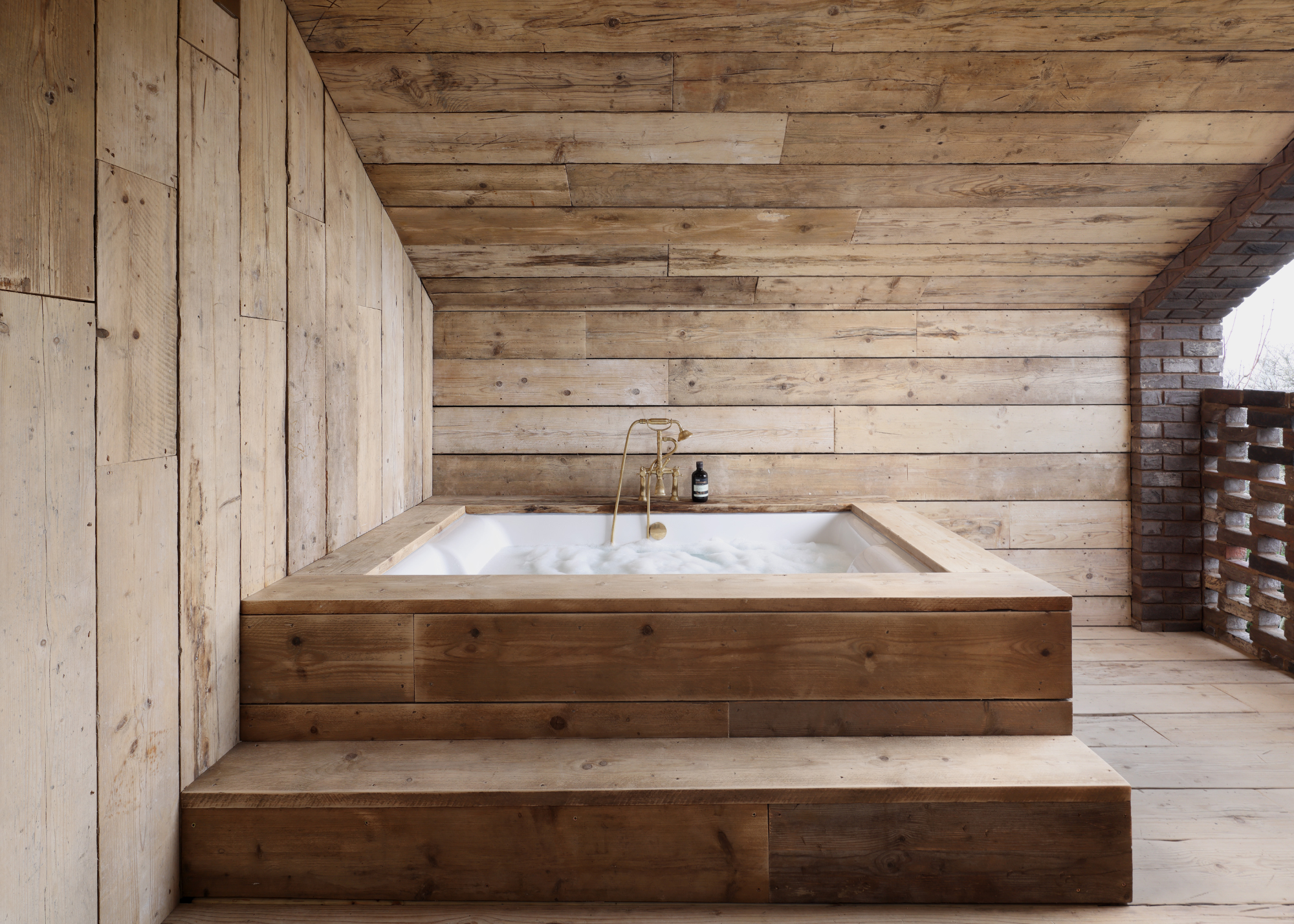 a wooden clad outdoor bath room