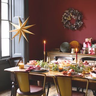table decorated for christmas in burgundy dining room
