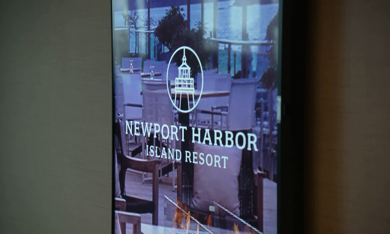 The Newport Harbor Island Resort lit up with digital signage.