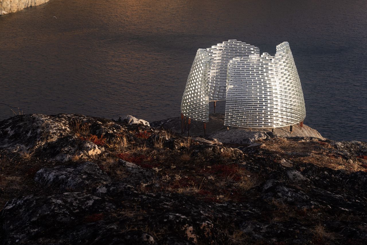 Day time image of the Konstantin Ikonomidis&#039;s pavilion located on the rocky terrain, back drop of water in the distance 