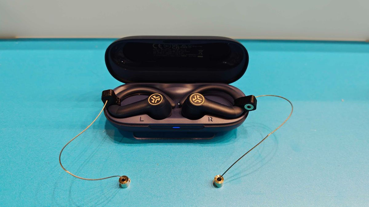 JLab's new earbuds at IFA, on a blue table