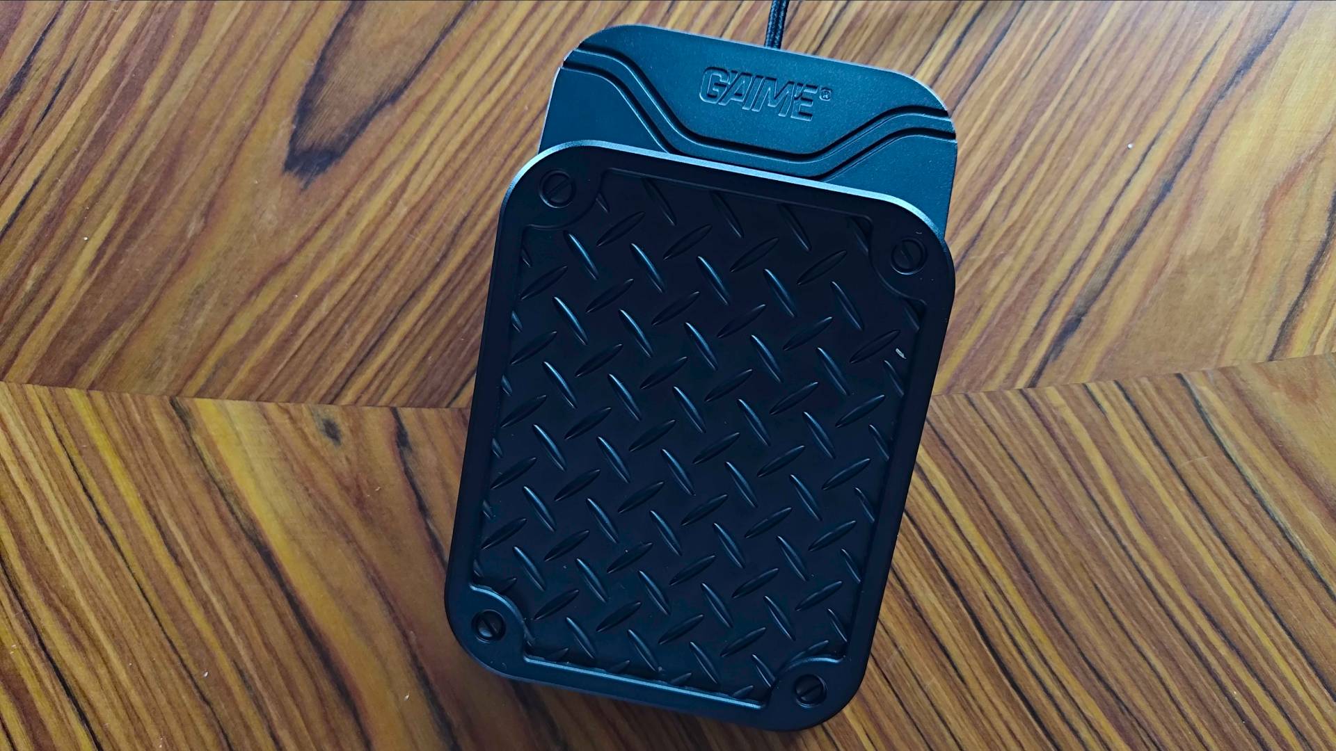 G&#039;AIM&#039;E Time Crisis console pedal on woodgrain table.