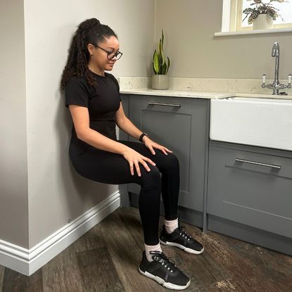 Rebecca trying the wall sits challenge at home