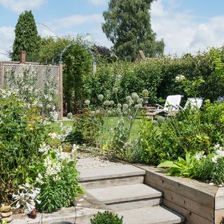 split level garden makeover with plant-packed borders