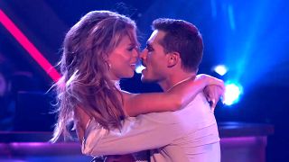 Brooks Nader and Gleb Savchenko stand face-to-face at the end of a performance on Dancing with the Stars Season 33.