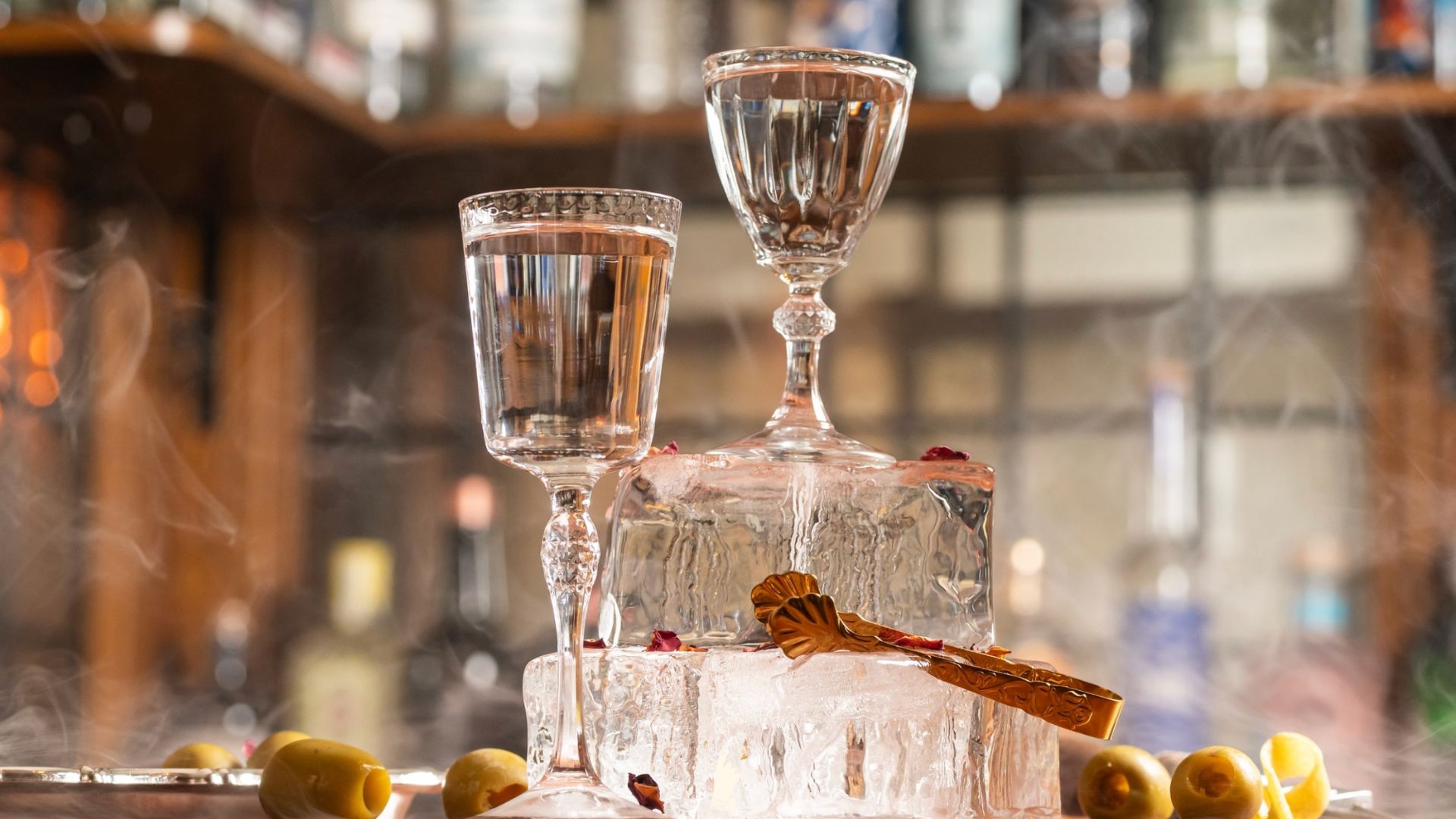 an image of two of the martini serves in glasses on top of blocks of ice