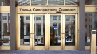 The Federal Communications Commission (FCC) logo on a building