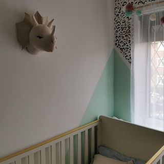 bedroom with white and green wall and celery panting on wall