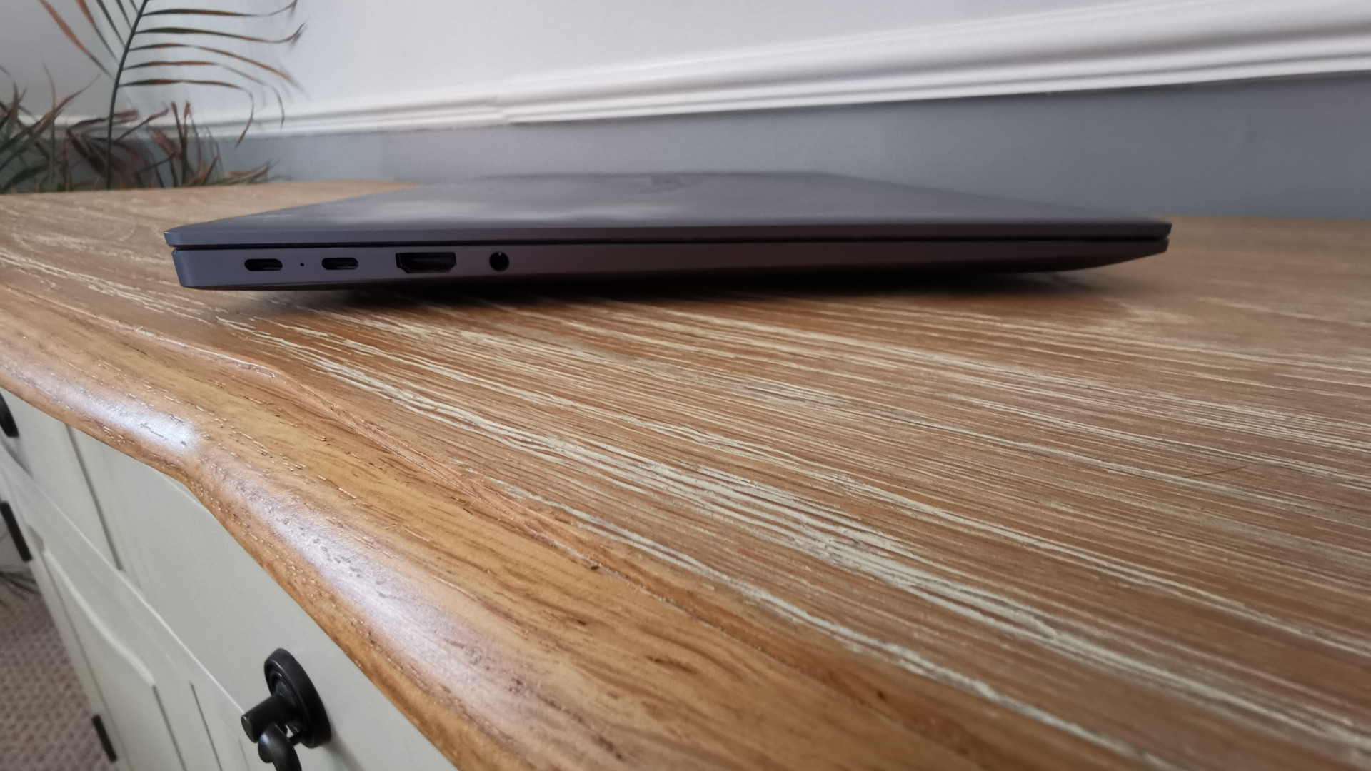 a Huawei MateBook 16 on a table from a side view