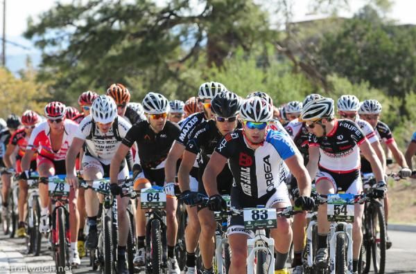 The men's peloton makes its way up the long road climb