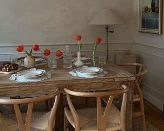 Kitchen with wooden table and vases of tulips