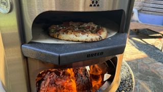 cooking pizza in the Breeo Live Fire pizza oven