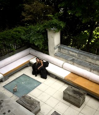 Michele Lamy photographed at home on her terrace, from above, as featured in one of Wallpaper's top 10 fashion posts of 2021