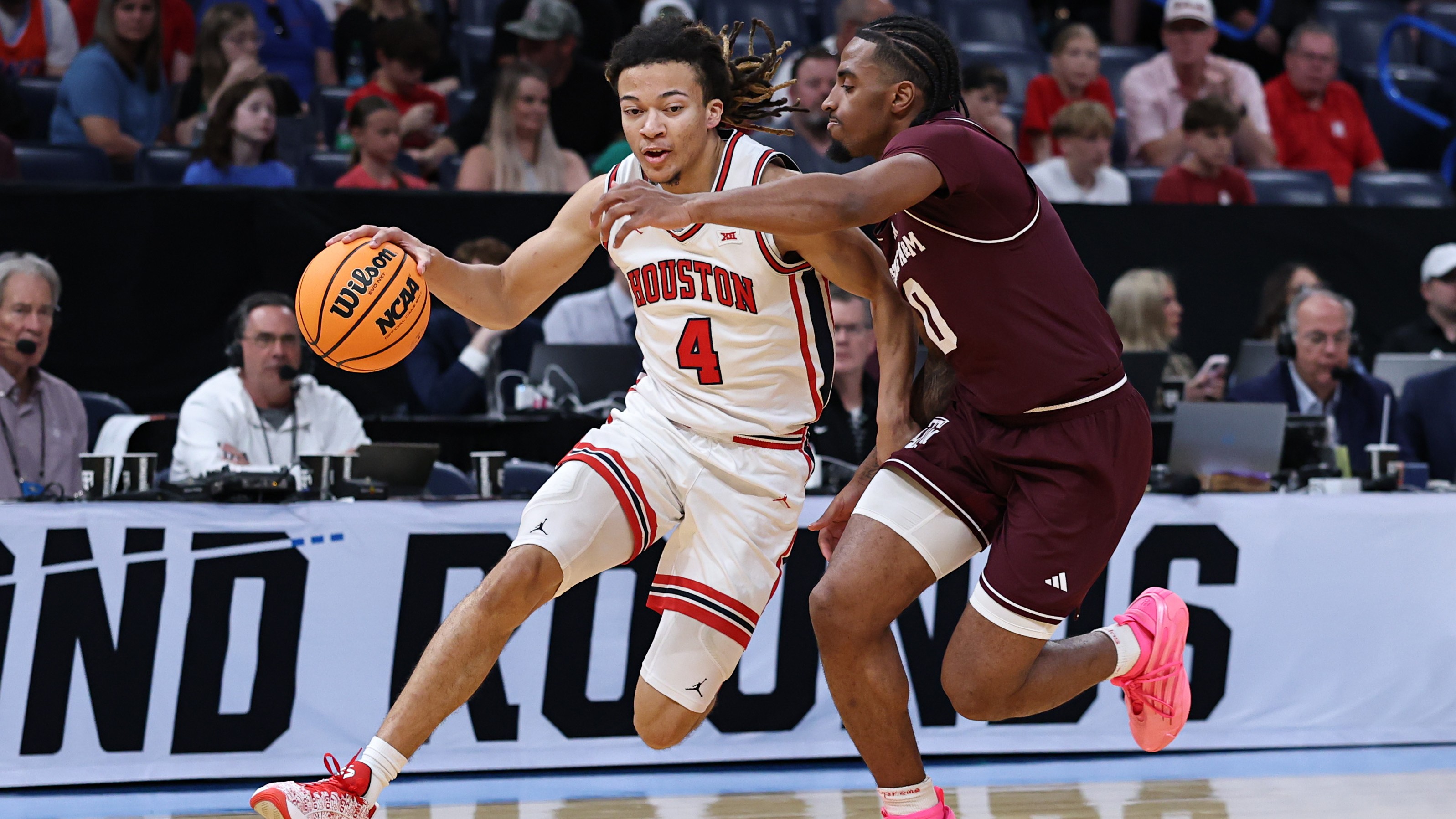 Kingston Flemings #4 of the Houston Cougars dribbles the ball against Marcus Hill #0 of the Texas A&amp;M Aggies during the first half in the second round of the 2026 NCAA Men's Basketball Tournament