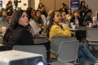 Two women intently listen at the 2024 #GALSNGEAR NAB Show event.