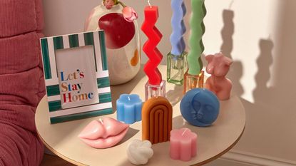 Collection of coloured candles on table