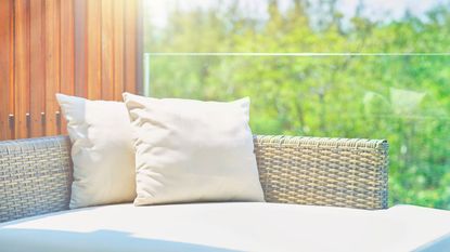 White outdoor cushions and pillows on an outdoor couch