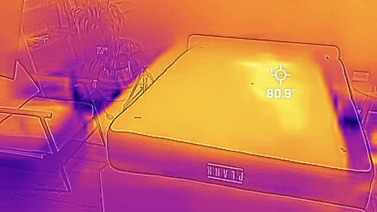 A thermal cam image showing the Plank Firm Luxe mattress in our testing studio. A pale yellow mark on one side of the bed indicates where our tester had been lying but it has faded somewhat, making the outline slightly tricky to spot.