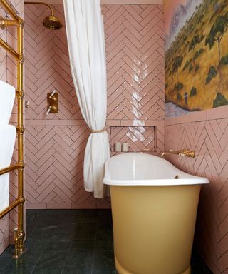 Pink bathroom, yellow bath tub, gold fixtures